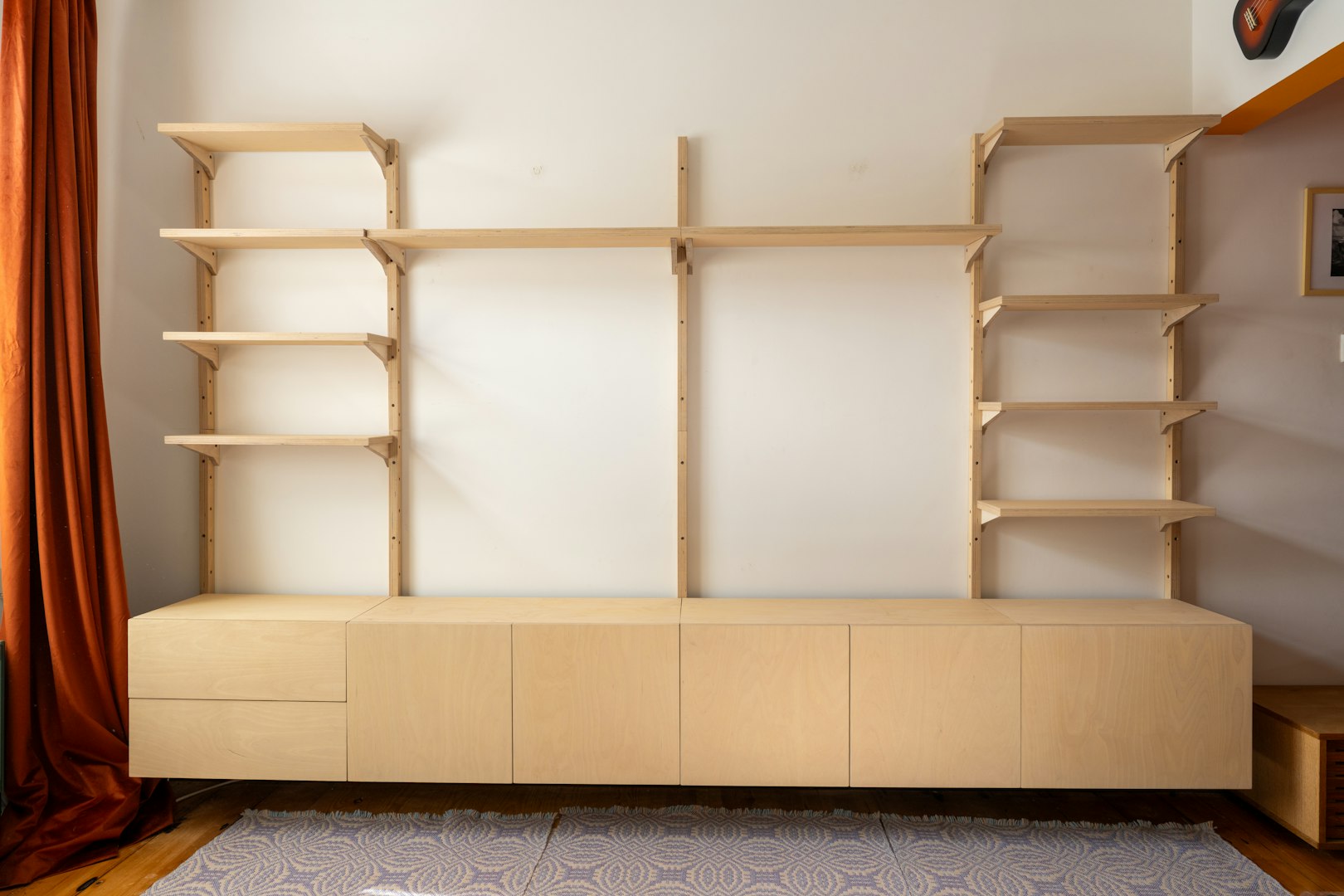 Man assembling kitchen drawer in modern cabinet using screwdriver. Handyman installing and adjusting drawer slide mechanism in contemporary kitchen. Furniture installation